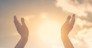hands reaching towards the sun